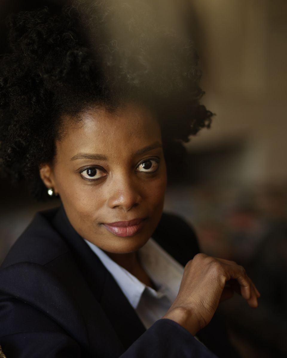Maud Nale in a navy suit with a soft smile