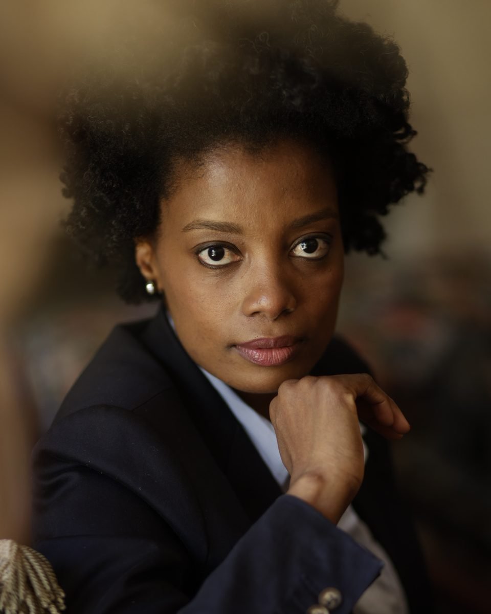 Maud Nale in a navy suit, chin resting on her hand, looking directly at the camera